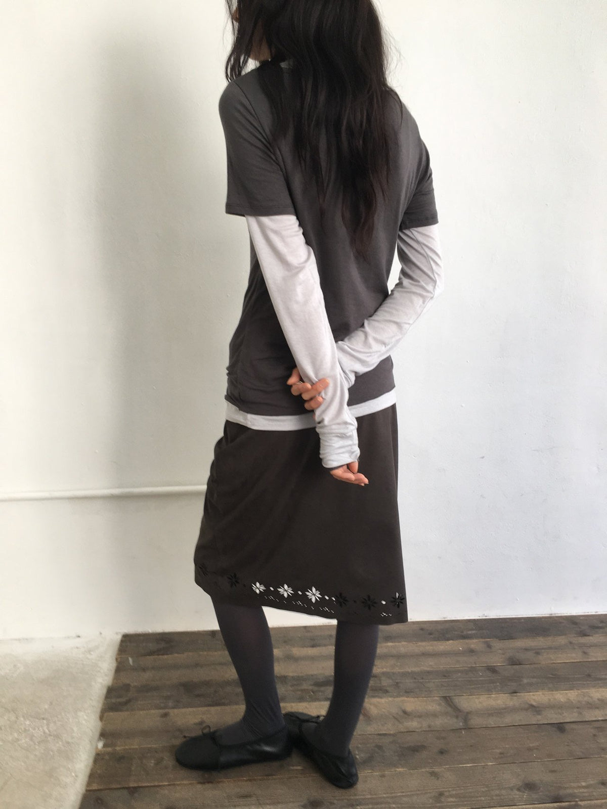 Pink floral cutout suede midi skirt styled with a charcoal cardigan