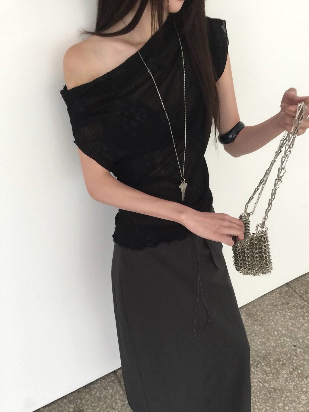 Nweol one-shoulder floral lace mesh top in Cream Ivory and Black, two colorways flat lay on wire rack