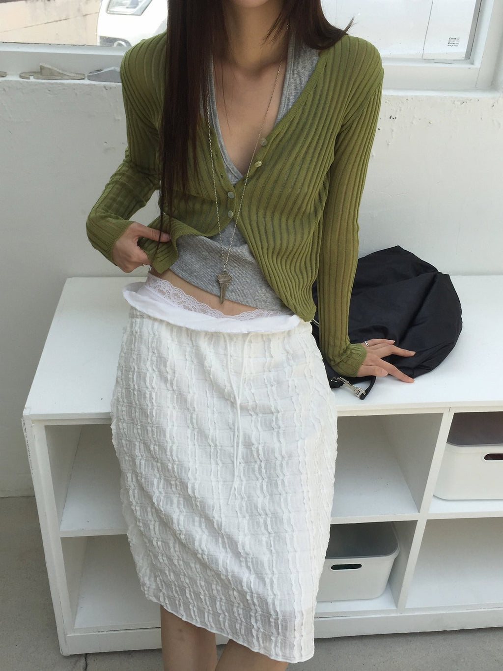 Nweol bubble texture midi skirt in Ivory, styled on model front view close-up waistband detail with olive cardigan