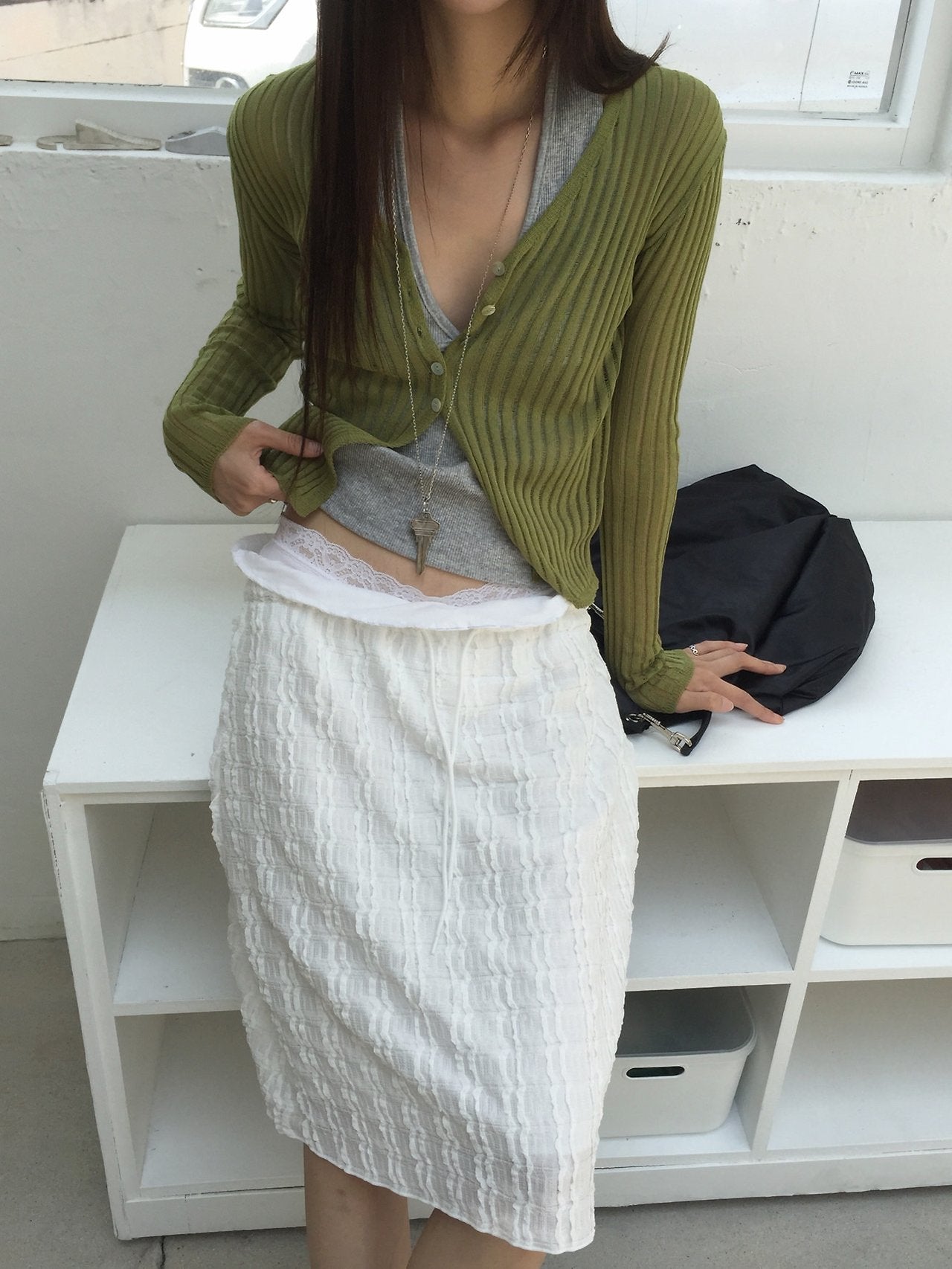 Nweol bubble texture midi skirt in Ivory, styled on model front view close-up waistband detail with olive cardigan