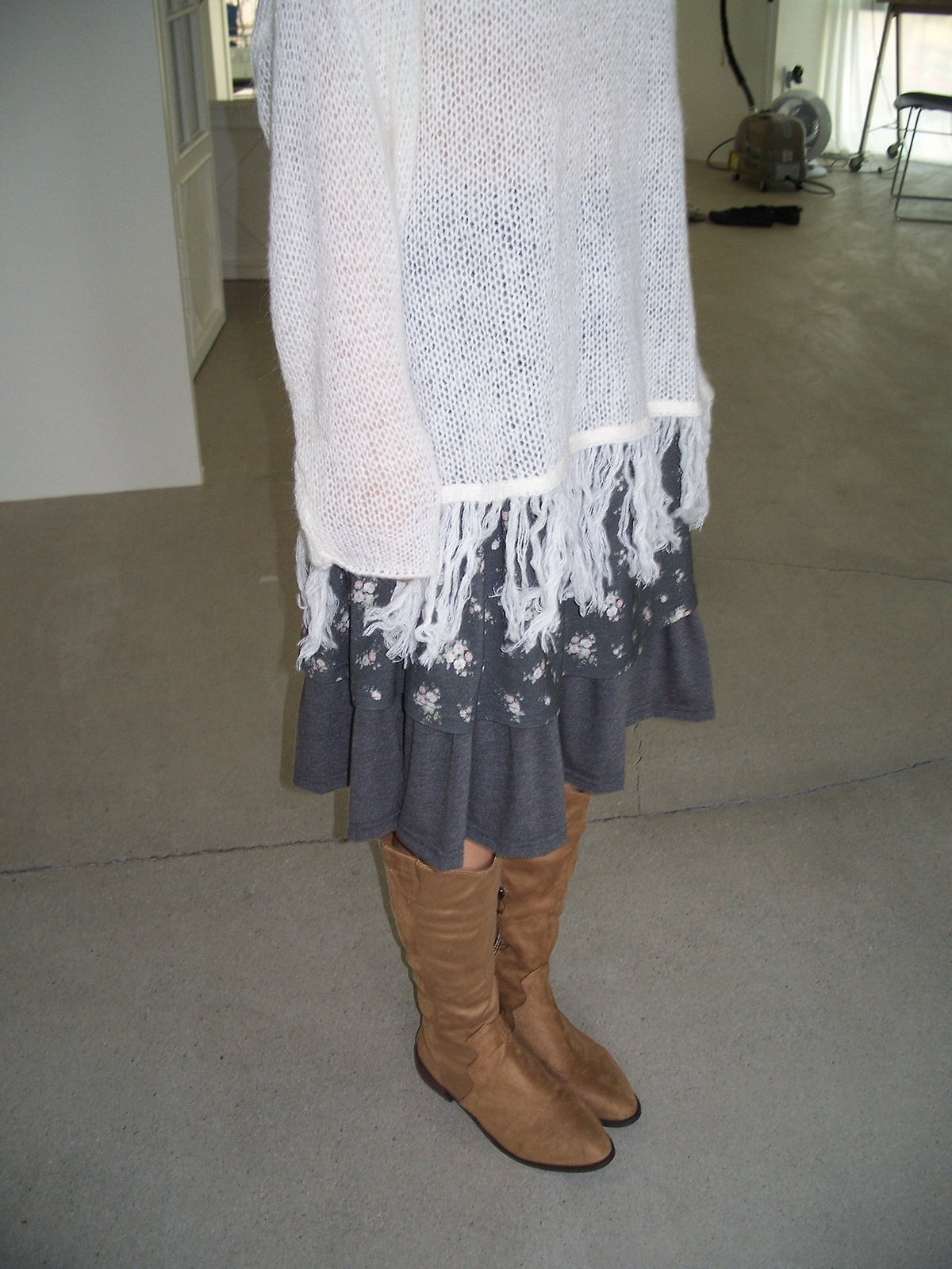 Open-Knit Fringe Sweater Ivory hanging on rack close-up fringe