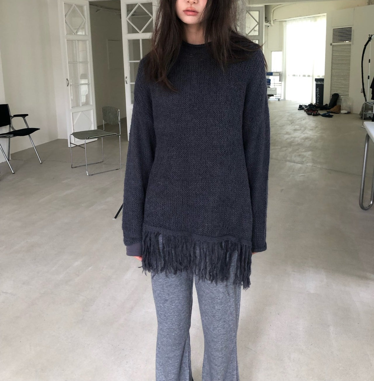 Open-Knit Fringe Sweater Charcoal hanging on rack close-up fringe