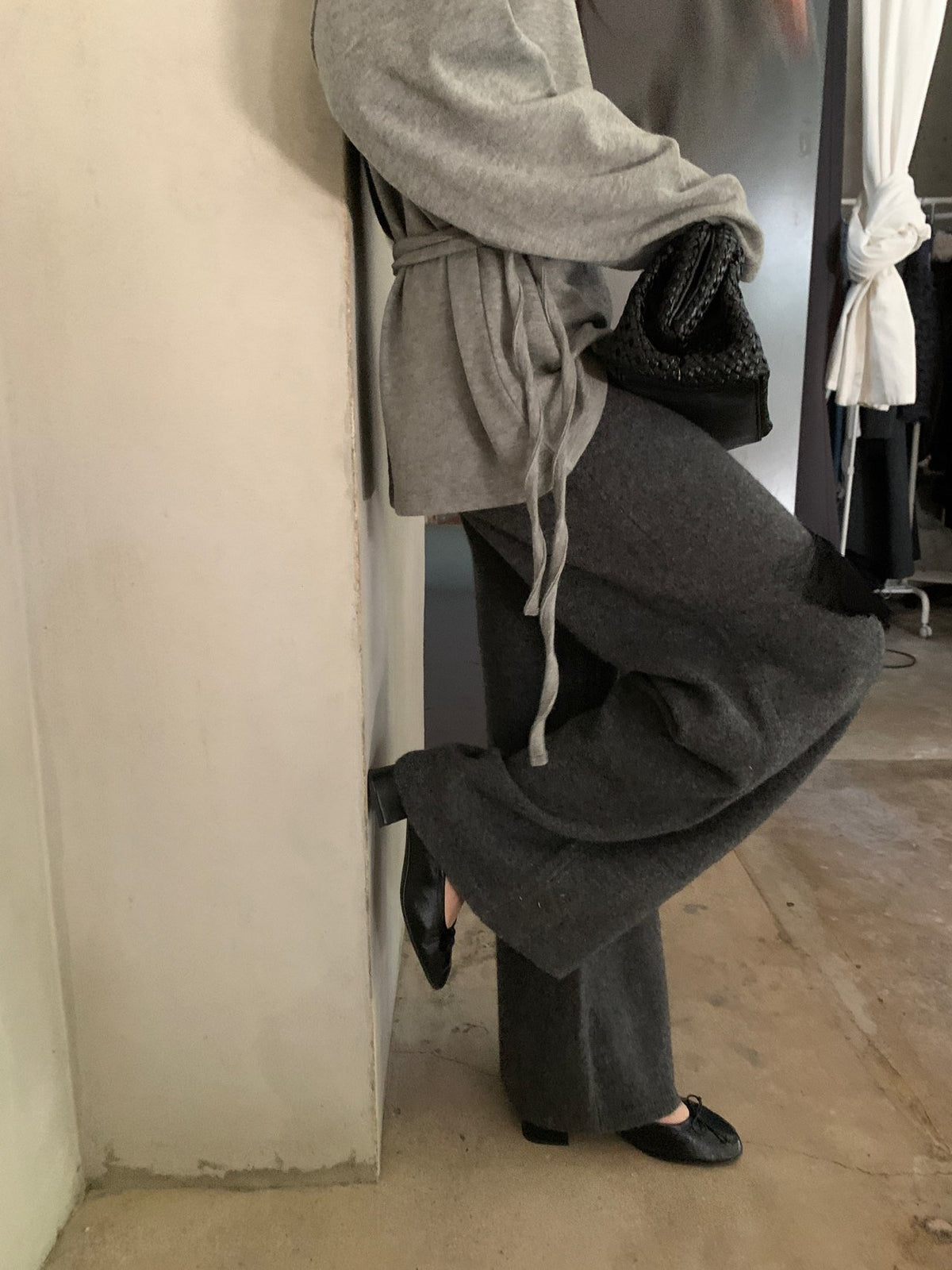 Black full-length wide-leg knit pants styled with a grey hoodie