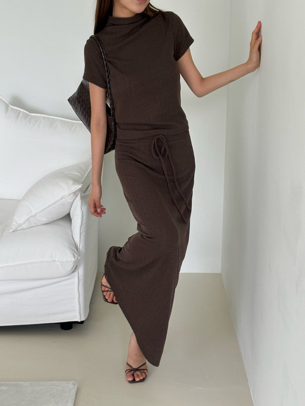 Full view of cream mock neck top and pleated maxi skirt set