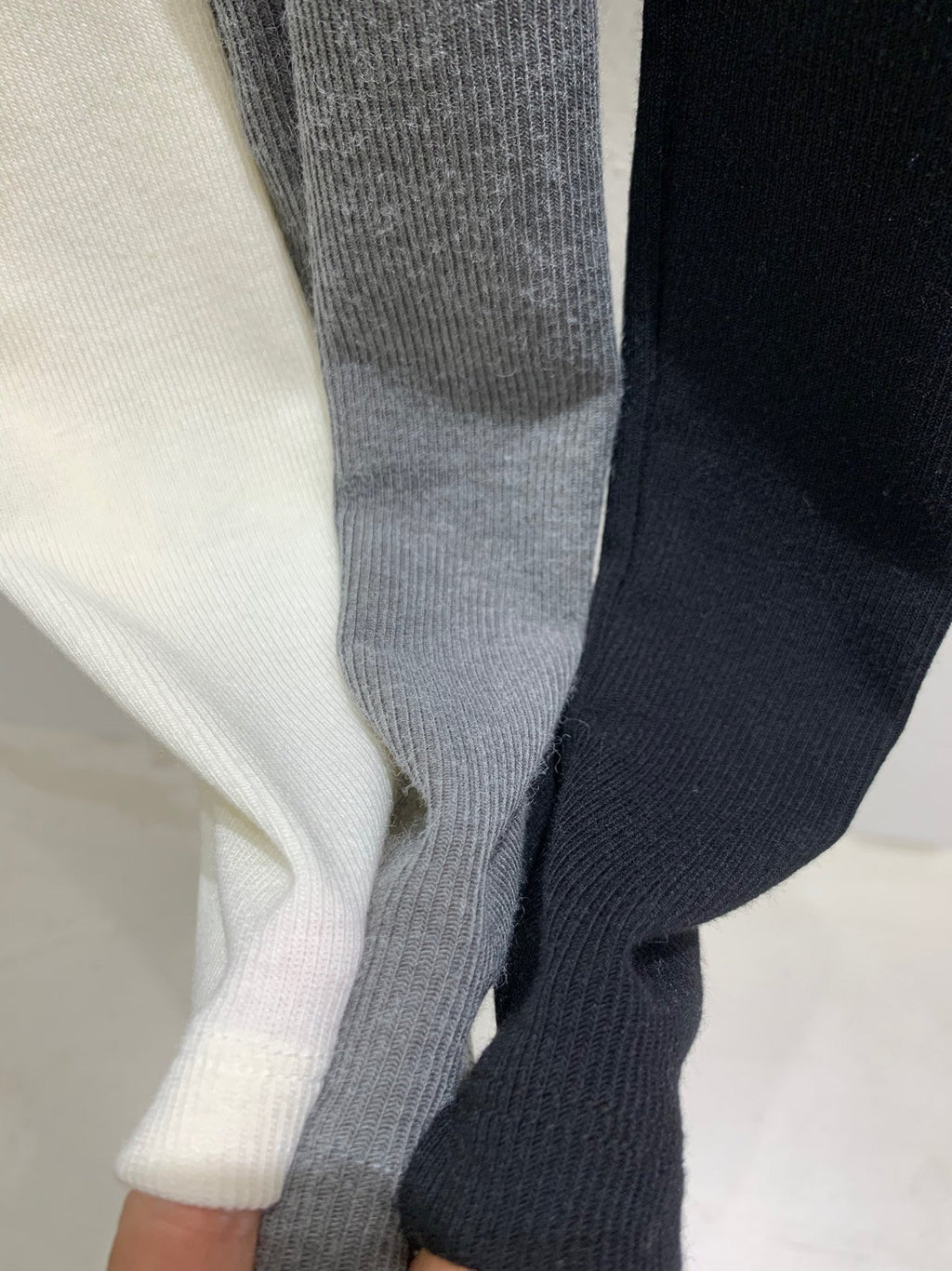Close-up of Lucysalon Ivory, Charcoal and Black ribbed fabric