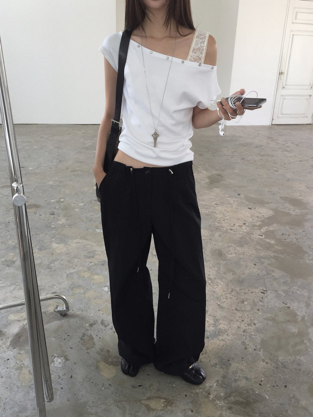 Nweol asymmetric one-shoulder top in Ivory, side view lace strap detail
