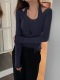 Navy halter tank top layered with a long-sleeve V-neck top