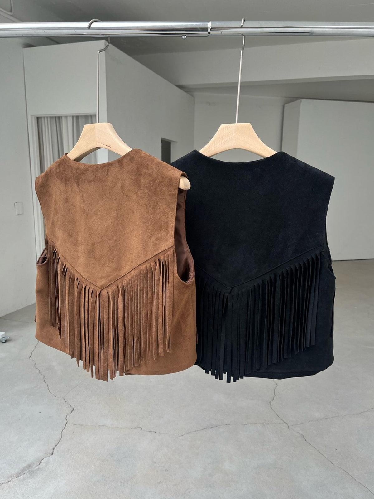 Suede Fringe Vest Black and Camel back view on hanger